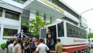 Red shirt leader Nattawut Saikua (centre) and other leaders wave to media as they leave at the Military court in Bangkok, yesterday.