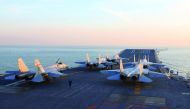 Chinese J-15 fighter jets waiting on the deck of the Liaoning aircraft carrier during military drills in the Bohai Sea. 