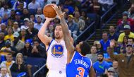Golden State Warriors guard Klay Thompson (left) shoots the basketball against New York Knicks guard Brandon Jennings during the third quarter at Oracle Arena in Oakland, California, US yesterday.