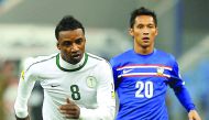 Saudi Arabia's Mohammed Noor (left) running with the ball during a football match against Thailand at King Fahad Stadium, in Riyadh, Saudi Arabia in this file photo of November 11, 2011. 