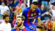 Barcelona's Lionel Messi (left) celebrates with Neymar (up) and Denis Suarez after scoring a goal against Valencia during their La Liga match in this file 
photo of October 23, 2016.