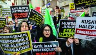 Protesters shout anti-Iran slogans and hold placards in front of the Iranian embassy in Istanbul yesterday, against Iranian involvement in the siege of Aleppo. 