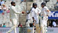 England's Liam Dawson (R) speaks with teammate Adil Rashid (C) as India's captain Virat Kohli (R) gestures during the second day of the fifth and final Test cricket match between India and England at The M.A. Chidambaram Stadium in Chennai on December 17,