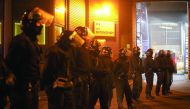 Police officers in riot gear stand outside Winson Green prison, run by security firm G4S, after a serious disturbance broke out, in Birmingham.