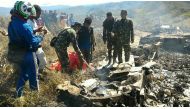 This handout picture released by search and rescue team and available on December 18, 2016 shows Indonesian soldiers examining the Hercules military plane A-1334 that crashed in Wamena on December 18, 2016. AFP / SEARCH AND RESCUE TEAM / HANDOUT