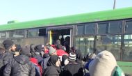 ALEPPO, SYRIA - DECEMBER 18 : Syrians wait to be evacuated from the east part of Aleppo that had been under siege by Assad Regime forces and its supporter foreign terrorist groups at a crossing point at Amiriyah district of Aleppo in Syria on December 18,