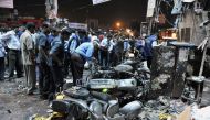 (FILES) This file photograph taken on February 21, 2013, shows Indian police and investigators at the site of a bomb blast at Dilshuk Nagar in Hyderabad. An Indian court on December 19, 2016, has sentenced two alleged leaders of a homegrown militant group