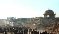 Syrians waiting to be evacuated from the east part of Aleppo, that had been under siege, at a crossing point in Amiriyah district of Aleppo, yesterday.