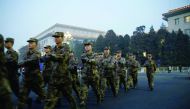 Soldiers patrol outside the Great Hall of the People on the fourth day after a red alert was issued for heavy air pollution in Beijing, yesterday. 