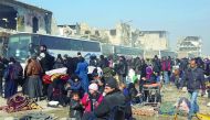 Syrians wait to be evacuated from the eastern part of Aleppo, that had been under siege by regime forces and its supporters, at a crossing point in Amiriyah district of Aleppo, yesterday.