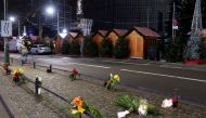 Candles and flowers are seen near the site where a truck ploughed through a crowd at a Berlin Christmas market on Breitscheidplatz square near the fashionable Kurfuerstendamm avenue in the west of Berlin, Germany, December 20, 2016. Reuters/Fabrizio Bensc