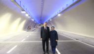 A handout picture released by the Turkish presidential press office shows Turkish President Recep Tayyip Erdogan (L) and his wife Emine Erdogan (R) posing in the tunnel on December 20, 2016 in Istanbul, during the opening cerenomy of the Avrasya (Eurasia)
