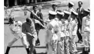 This file photograph taken on July 30, 1987, shows former Indian Prime Minister Rajiv Gandhi (C) ducking a rifle butt attack by a Sri Lankan naval rating during an honour guard in Colombo, after the visiting Indian leader signed a controversial peace pact