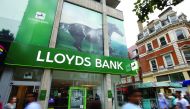 People walk past a branch of Lloyds Bank on Oxford Street in London.