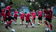 (FILES) This file photo taken on January 12, 2016 shows children attending a football training session in the suburbs of Guangzhou in southern China's Guangdong province.  AFP / JOHANNES EISELE 
