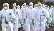 Quarantine officials in protective gears head to a poultry farm in Kawaminami, Miyazaki Prefecture, southwestern Japan to bury chickens culled after a highly virulent strain of bird flu was detected in this photo taken by Kyodo December 20, 2016. Kyodo vi