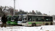 ALEPPO, SYRIA - DECEMBER 21: A convoy, evacuating civilians who flee from Assad regime supporter foreign terrorists controlled Fua and Kefraya towns those had been under siege by opposition groups, move forward Assad regime controlled western rural parts 