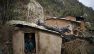 In this 2014 archive photo a 14-year old girl sits inside a Chaupadi shed in the hills of Legudsen village in Achham District in western Nepal. REUTERS/Navesh Chitrakar