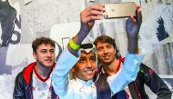A Qatari football fan takes a selfie with AC Milan players Montolivo and Calabria during their visit to the adidas store at Villaggio Mall yesterday.