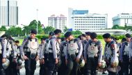 Indonesian anti-riot police take part in a roll call in Jakarta,  yesterday, as part of efforts to secure holidays celebrations.