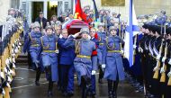 The casket of slain Russian ambassador to Turkey, Andrei Karlov, is carried out of the Russian Foreign Ministry in Moscow after a memorial service, yesterday.