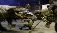 Japan's ON-ART Corp's eight metre tall human-operated walking dinosaur robot 'TRX03' (C) performs with other robots at the company's studio in Tokorozawa, Japan, December 6, 2016. REUTERS/Toru Hanai 