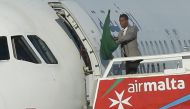 One of the hijackers of a Libyan Afriqiyah Airways Airbus A320 waves a Gaddafi-era Libyan flag at Malta Airport, December 23, 2016. REUTERS/Darrin Zammit
