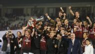 Players of AC Milan raise trophy after winning the Italian Super Cup final match between Juventus and AC Milan at Jassim Bin Hamad Stadium in Doha, Qatar on December 23, 2016. ( Mohammed Dabbous - Anadolu Agency )
