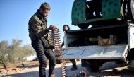 Members of Free Syrian Army carry bullets as they advance to al-Bab town of Aleppo during the 