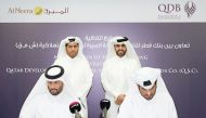 Abdulaziz bin Nasser Al Khalifa (standing right), CEO of QDB; and Chairman of the Board of Directors, Al Meera Company, Sheikh Thani bin Thamer bin Mohamed Al Thani, witnessing the MoU signing ceremony at QDB Headquarters in Doha recently. 