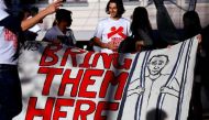 Refugee advocates hold a banner during a protest in central Sydney, Australia, on Oct 5, 2016, calling for the closure of the Australian detention centres located in Nauru and Manus Island. PHOTO: REUTERS.