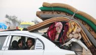 A convoy, evacuating civilians and opposition group members who left east Aleppo that had been under siege by Assad regime and its supporter foreign terrorists, arrive in opposition controlled Rashideen Town of Aleppo, Syria on December 22, 2016 . ( Ahmed