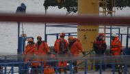 Russian Emergencies Ministry members walk on a pier near the crash site of Russian military Tu-154 plane in the Black Sea in the Sochi suburb of Khosta, Russia December 25, 2016. REUTERS/Maxim Shemetov