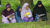 Family members gather to pray for their loved ones at a mass grave in Aceh on December 26, 2016, to mark the tsunami which devastated Aceh province 12 years ago in one of the worst natural disasters in human history. AFP / CHAIDEER MAHYUDDIN
