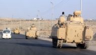 A convoy of Egyptian armoured vehicles travel along a road in El-Arish in the Sinai Peninsula. Photo: AFP