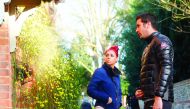 A man and a woman look at tributes outside the house of singer George Michael, where he died on Christmas Day, in Goring, southern England, yesterday.