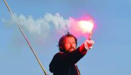 French skipper Thomas Coville holds a burning flare onboard his 