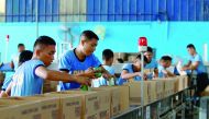 Personnel from the Philippine National Police (PNP) pack boxes with relief goods.