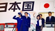 Japan's Prime Minister Shinzo Abe and Defence Minister Tomomi Inada (third left) wave as they depart for Hawaii at Tokyo's Haneda Airport, yesterday.