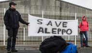 Participants of the solidarity march to Aleppo hold a banner reading 