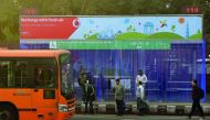 Commuters waiting for their ride at a bus stop where air purifiers have been installed  in New Delhi, yesterday. 