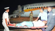 Rescue and Navy personnel moving an injured passenger away from a damaged Jet Airways Boeing 737 after it skidded off the runway at the Goa Airport in Dabolim, yesterday.