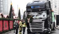 This file photo taken on December 20, 2016 shows firemen inspecting the truck that crashed the evening before into a Christmas market at Gedaechtniskirche church in Berlin. German police on December 28, 2016 detained a Tunisian national on suspicion of ha