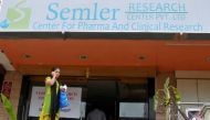 A woman talks on a mobile phone as she walks past the closed research facility of Semler Research Centre in Bengaluru, India, October 13, 2016. REUTERS/Abhishek N. Chinnappa
