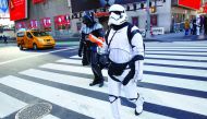 People dressed as Darth Vader and a Stormtrooper from Star Wars Rogue One walk at Times Square in Manhattan