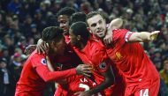 Liverpool's Roberto Firmino (left) celebrates with team-mates including Liverpool's Jordan Henderson (right) after scoring their second goal against Stoke City during their Premier League match at Anfield in Liverpool, England on Tuesday.