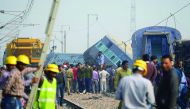 Police officials and bystanders gathering at the derailed train carriages in Rura, near Kanpur,  yesterday.