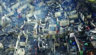 Residents sift through the ruins of their houses after a fire razed a squatter colony, in Quezon city, Metro Manila in the Philippines December 28, 2016. REUTERS/Erik De Castro