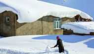 A man shovels away some snow during inclement weather conditions in Van, Turkey on December 27, 2016. Weather affects the everyday lives of people at Yukari Narlica district of Van in Eastern Anatolia Region of Turkey. ( Ali ?hsan Öztürk - Anadolu Agency 
