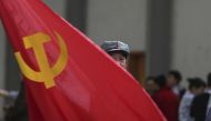 A participant waves a  flag as he waits backstage before his performance at a line dancing competition in Kunming, Yunnan province, January 31, 2015 (REUTERS)